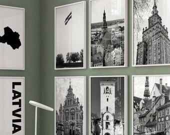 May include: A gallery wall set of eight framed prints featuring black and white photography of Latvian architecture, a map of Latvia, and the text LATVIA in a vertical sans-serif font, all displayed in thin white frames against a sage green wall.