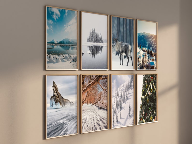 May include: A collection of eight framed winter landscape photographs, featuring snowy scenes, a reindeer, a frozen lake, and a Christmas tree.