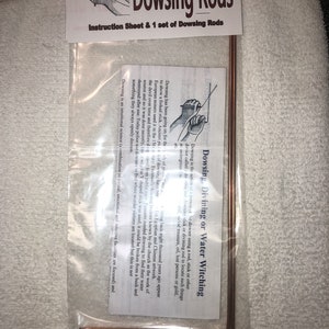 May include: A set of copper dowsing rods in a clear plastic bag with an instruction sheet. The sheet explains the history of dowsing and how to use the rods to find water, buried treasure, or lost objects.