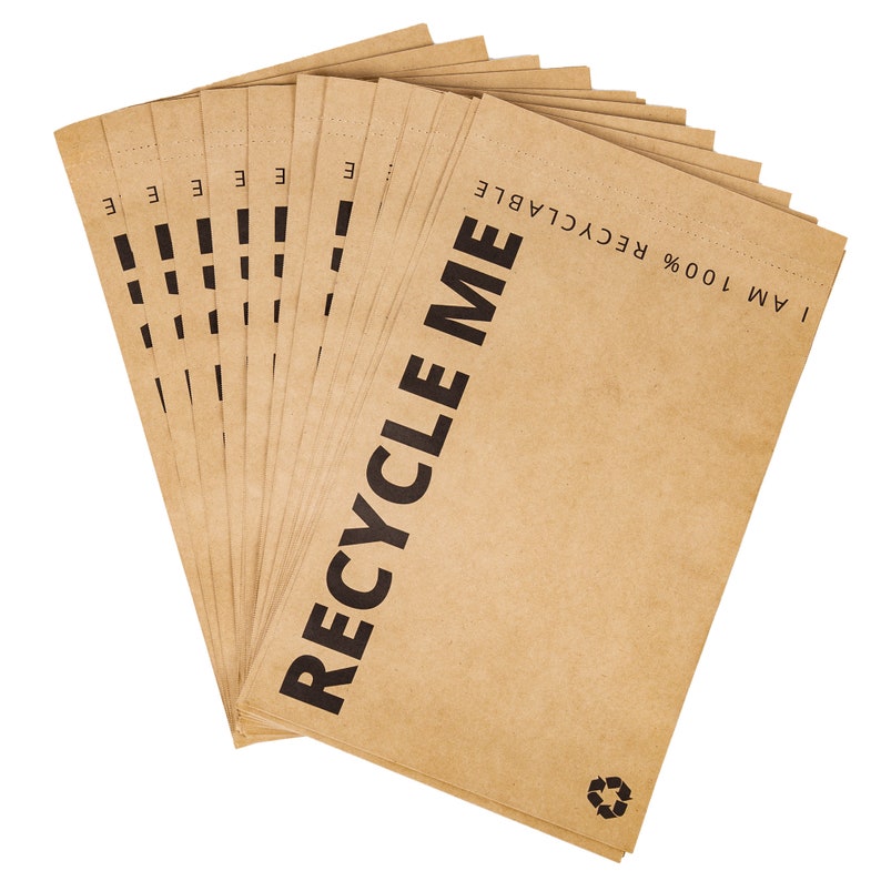 May include: A stack of brown paper bags with the text "I AM 100% RECYCLABLE" and "RECYCLE ME" printed on them.