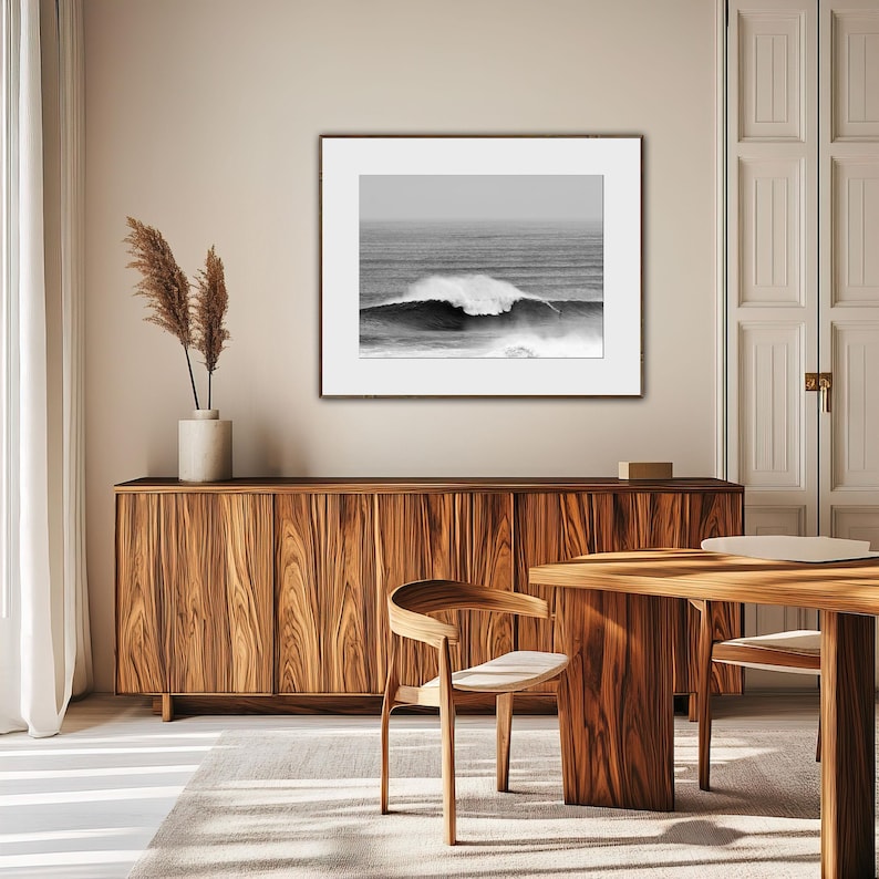 Minimalist surf photo in black and white tones, displayed in a Japandi-inspired living room with natural wood and soft textures. A quiet yet powerful statement piece, blending movement, nature, and balance. Digital download photography print.