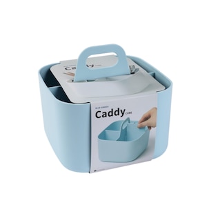 May include: A light blue plastic caddy with a handle and four compartments. The caddy has the text "Caddy Cube" printed on the side.