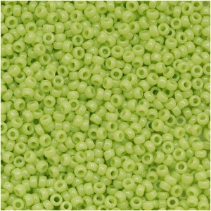 May include: A large quantity of small, light green glass beads. The beads are round with a hole in the center.