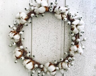 Christmas wreath with natural white dried cotton flowers and white berries, winter wreath for home decoration front door