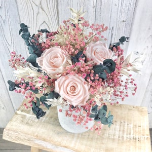 Bouquet of dried flowers with preserved roses, preserved eucalyptus and pink gypsophila, dried bridal bouquet