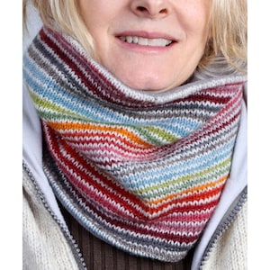 May include: A colorful striped knit neck warmer with a variety of colors including red, orange, yellow, green, blue, and grey.