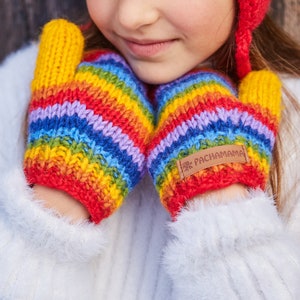 May include: A pair of rainbow striped knitted mittens with a brown leather tag that says "Pachamama".
