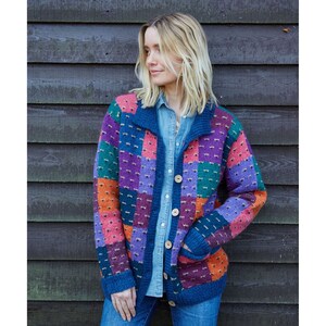 May include: A colorful patchwork cardigan with a button-up front. The cardigan is made of a soft, textured yarn and features a variety of colors, including purple, blue, green, orange, and pink.