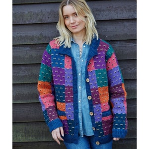 May include: A multi-colored cardigan with a patchwork design in shades of blue, green, purple, orange, and pink. The cardigan has a button closure and two pockets.