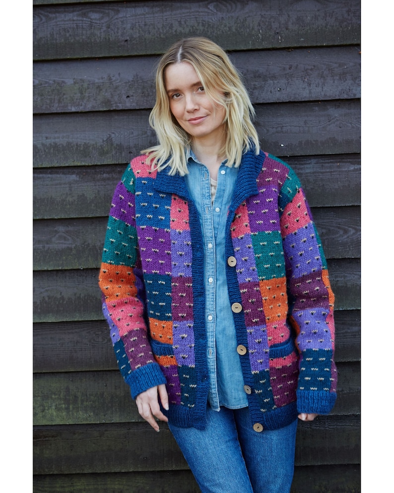 May include: A multi-colored cardigan with a patchwork design in shades of blue, green, purple, orange, and pink. The cardigan has a button closure and two pockets.