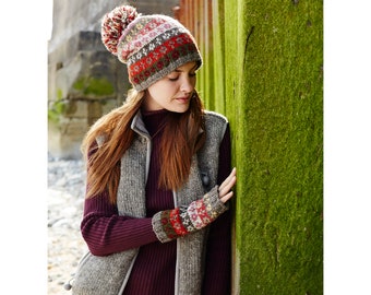 May include: A woman wearing a grey and brown vest with a red, green and white patterned knitted hat and matching fingerless gloves.