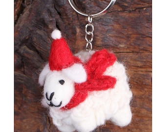 May include: White felt sheep keychain with a red Santa hat and scarf.