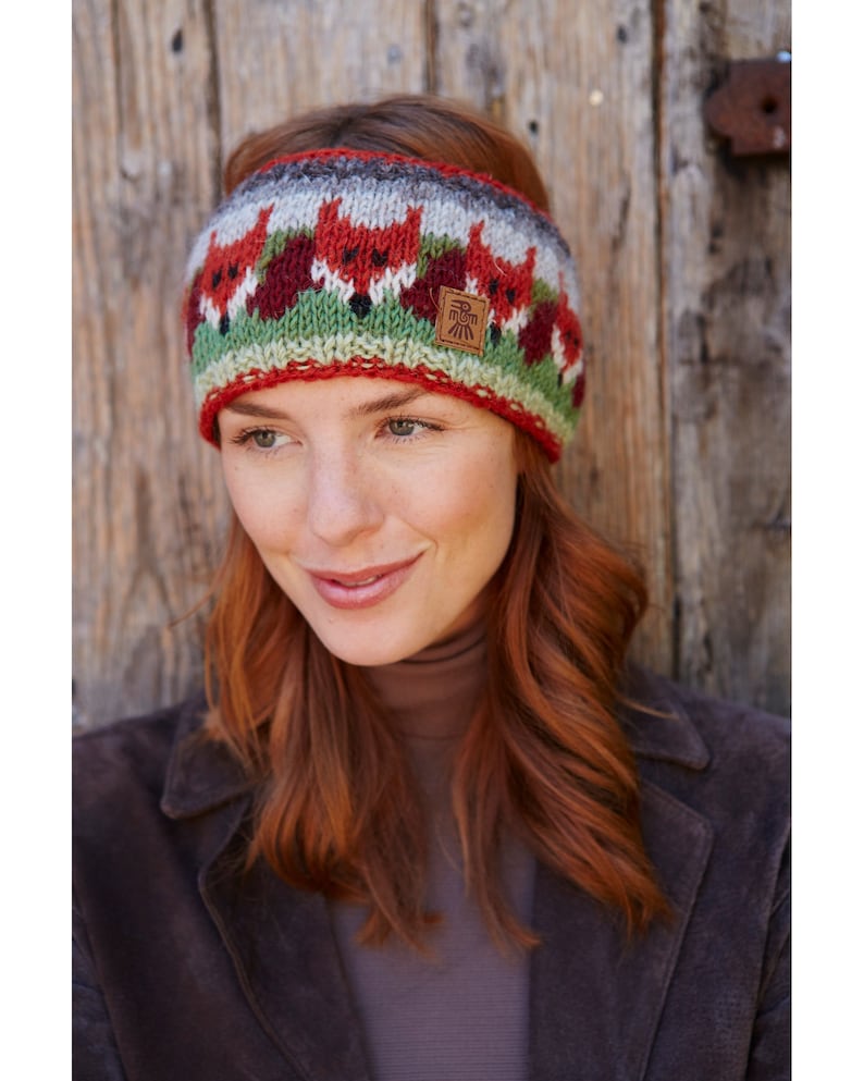 Hand knitted 100% sheep wool knitted headband. Orange fox heads on a green, red and grey background. Stocking stitch with rib hem. Fleece lined.