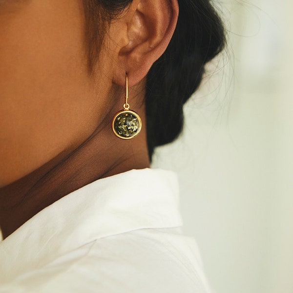 Bold round green amber earrings set in gold-plated sterling silver.