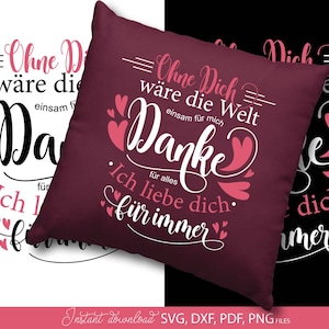 Puede incluir: Un cojín burdeos con texto blanco y rosa. El texto incluye frases como "Ohne Dich wäre die Welt" y "Danke". Corazones decorativos acentúan el texto. El cojín tiene forma cuadrada.