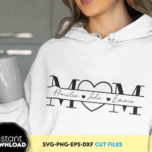 May include: A white hoodie with a black graphic design that says "MOM" with a heart and the names Amelia, John, and Emma underneath. The graphic is on a white hoodie with a hood.