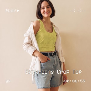 May include: A lime green sleeveless crop top with a subtle vertical striped pattern, worn under an unbuttoned white long-sleeved shirt paired with light blue denim shorts and a black belt. The text Backrooms Crop Top is visible on the image.