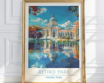 May include: A framed art print of Retiro Park in Madrid, Spain. The artwork depicts a grand building with a domed roof reflected in a lake. The sky is blue with fluffy clouds, and the scene is framed by colorful trees.