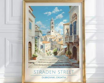 May include: A framed print of Straden Street in Dubrovnik, Croatia. The artwork depicts a stone staircase leading up to a church with a tall bell tower. The buildings are white with orange tile roofs, under a blue sky.