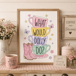 May include: A framed wall art print featuring a stack of four colourful teacups with the text WHAT WOULD DOLLY DO? and a pair of pink cowboy boots. The design includes small illustrations of butterflies, stars, and flowers on a white background.