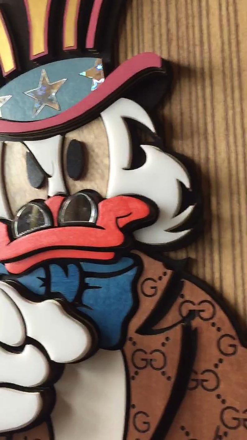 May include: A cartoon duck wearing a red, white, and blue top hat with stars and a brown jacket with a black and white GG pattern. The duck has a red beak and white feathers.