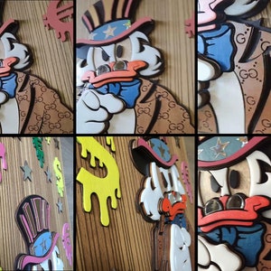 May include: A wooden wall art piece featuring a cartoon Uncle Sam character with a white beard and a blue bow tie. The character is wearing a red, white, and blue hat and a brown jacket with a Gucci pattern. The background is a wooden panel with a dripping paint effect in pink, yellow, and green.