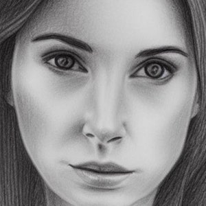 May include: A black and white pencil drawing of a woman's face. The woman has long dark hair, dark eyebrows, and dark eyes. Her lips are slightly parted.