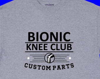 May include: A gray t-shirt with the text "Bionic Knee Club Custom Parts" and a graphic of a knee with a prosthetic joint.