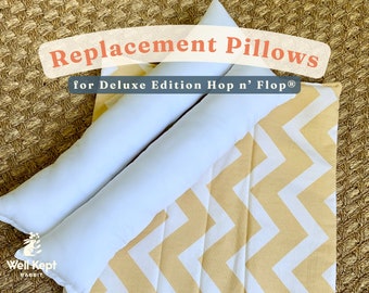 May include: Two white replacement pillows for a Deluxe Edition Hop 'n' Flop rabbit hutch. The pillows are on top of a yellow and white chevron patterned fabric.