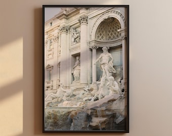 May include: A black and white photograph of the Trevi Fountain in Rome, Italy. The fountain is a large, ornate structure with a statue of Oceanus in the center. The fountain is surrounded by sculptures of sea nymphs and other mythical creatures.