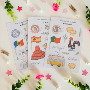 May include: Three white sticker sheets from The Aesthetics Studio featuring illustrations of Andorra, Spain, and Portugal. Each sheet displays national flags, regional landmarks, cultural icons like a rooster and tram, and cursive text labels.
