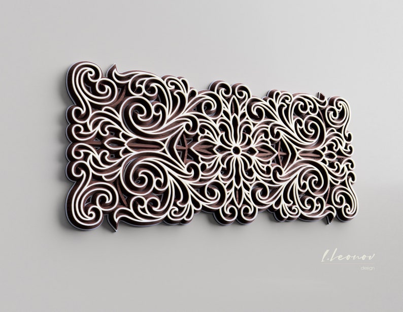 May include: An intricate decorative wall art piece in brown and white with a floral design. The art piece is made of wood and has a 3D effect.