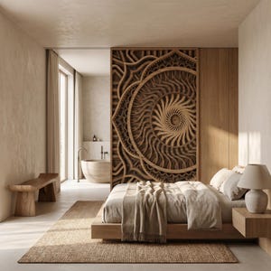 May include: A large, circular, multi-layered wooden wall art piece with intricate, radiating geometric patterns serves as a room divider between a bedroom and a bathroom, featuring a low-profile bed, a wooden bench, and a bedside lamp.