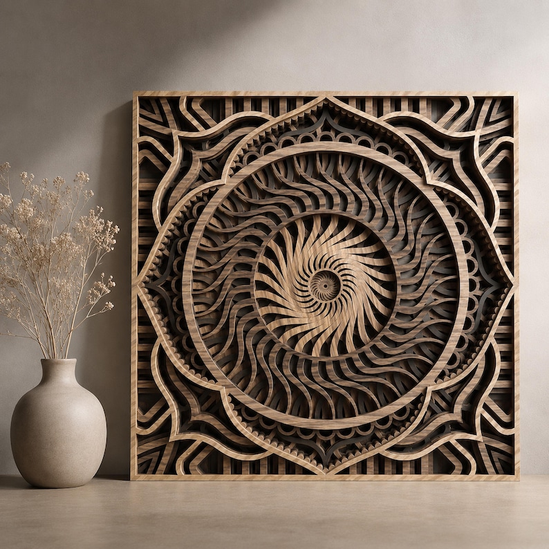 May include: A square wooden wall art piece featuring a multi-layered mandala design with intricate, swirling patterns in shades of dark and light brown wood, displayed next to a light-colored ceramic vase containing dried, delicate beige flowers.