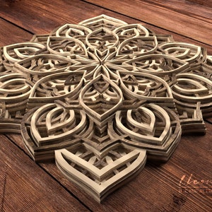 May include: A layered wooden mandala with a intricate geometric design. The mandala is made of multiple layers of wood, each with a different pattern. The mandala is a popular decorative element in many cultures.