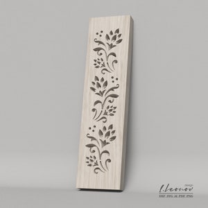 May include: A wood panel with a decorative floral design cut out. The design features a repeating pattern of stylized flowers and leaves.