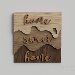 May include: A wooden sign with the words "home sweet home" carved into it. The words are layered on top of each other, creating a 3D effect. The sign is made of light and dark wood, giving it a rustic look.