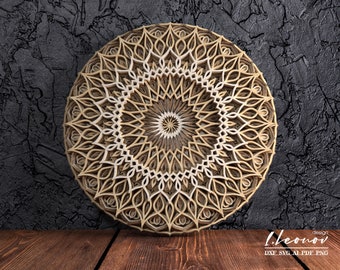 May include: A layered wooden mandala with a detailed, symmetrical design. The circular artwork features concentric patterns in shades of beige and brown, creating a three-dimensional effect. The background is a dark, textured surface.