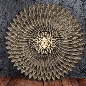 May include: A large, intricate, wooden wall decor in the shape of a flower with a geometric design. The flower is made of multiple layers of wood, creating a 3D effect. The flower is painted in a gold color and has a dark brown background.