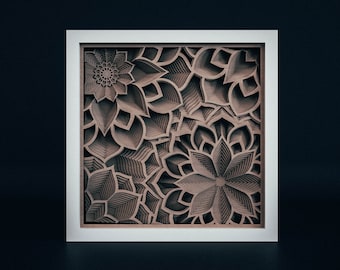 May include: A white framed wall art piece with a brown, layered, intricate design of overlapping flowers.