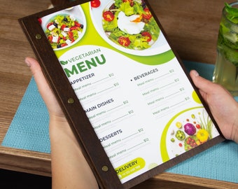 May include: A brown wooden menu with a green and white vegetarian menu. The menu has a title that says "Vegetarian Menu" and lists appetizers, main dishes, desserts, and beverages. The menu has a price of $12 for each item.