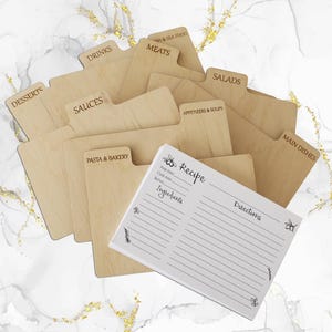 May include: A collection of wooden recipe dividers and a recipe card. The dividers are labeled with categories like "Desserts," "Drinks," and "Meats." The recipe card has space for ingredients and directions, with the word "Recipe" at the top.