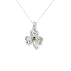 May include: A silver necklace featuring a shamrock pendant. The shamrock is decorated with clear and green cubic zirconia stones.