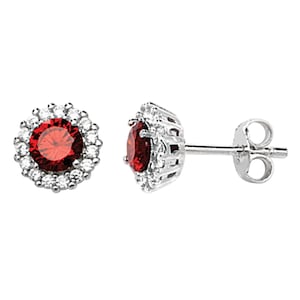 May include: A pair of silver stud earrings featuring a red gemstone surrounded by a halo of smaller white gemstones.