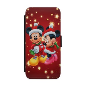Puede incluir: Una funda de teléfono roja con un diseño navideño con Mickey Mouse y Minnie Mouse con gorros de Papá Noel. El fondo es rojo con estrellas doradas.