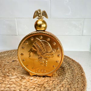 Vintage Avon Coin Decanter – Gold Liberty Bottle with Eagle Top – Bar Cart or Man Cave Decor