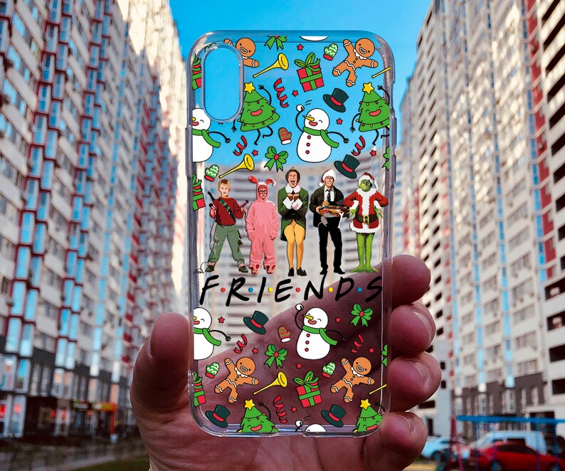 May include: A clear phone case with a Christmas theme featuring characters from the movie. The case has a white background with red, green, and blue accents.