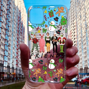 May include: A clear phone case with a Christmas-themed design featuring characters from the movie "Friends" and the words "FRIENDS".