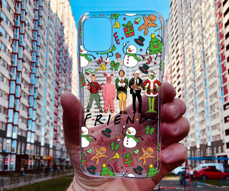 May include: A clear phone case with a Christmas-themed design featuring characters from the movie "Friends" and the words "FRIENDS".