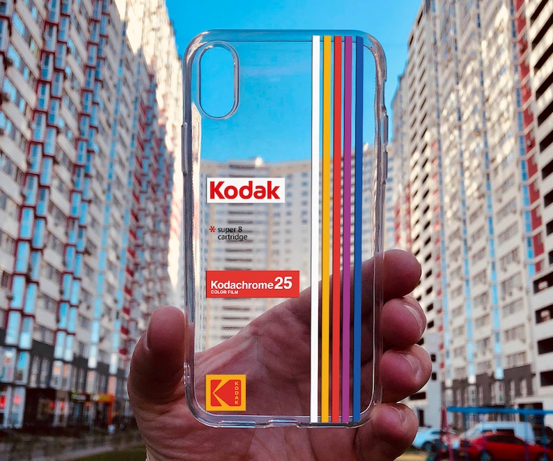 May include: Clear phone case with a 25 film cartridge design. The case has a rainbow stripe design and the text "super 8 cartridge" and "25 color film".